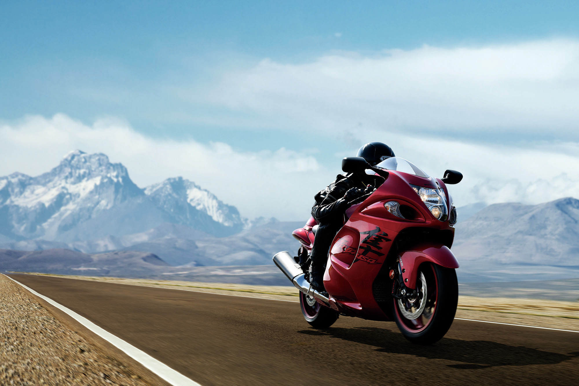 red hayabusa on highway with mountain landscape